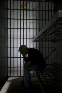 Prisoner in jail cell.