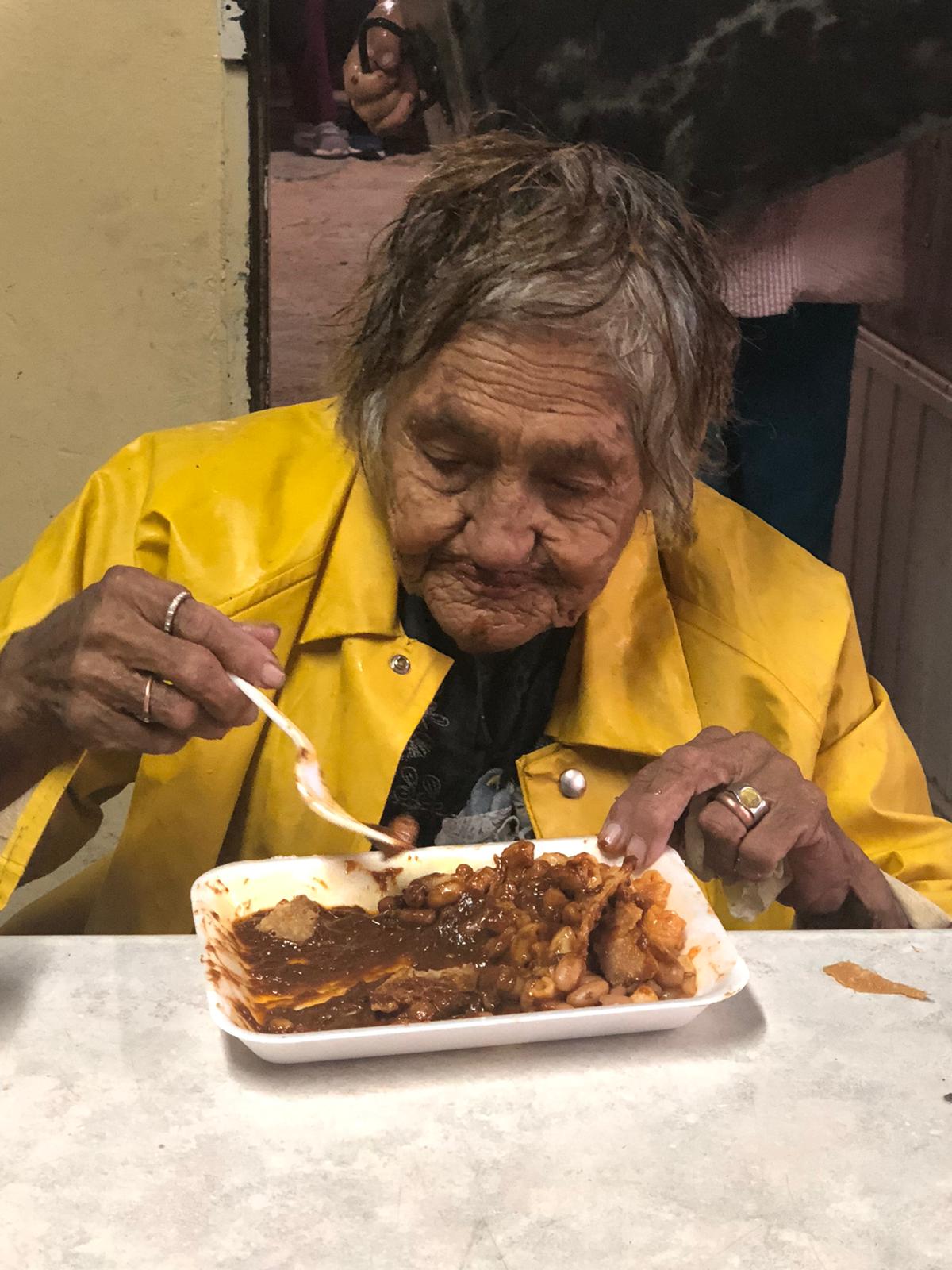 One of our elderly enjoying a hot meal at the Lord's Food Bank.