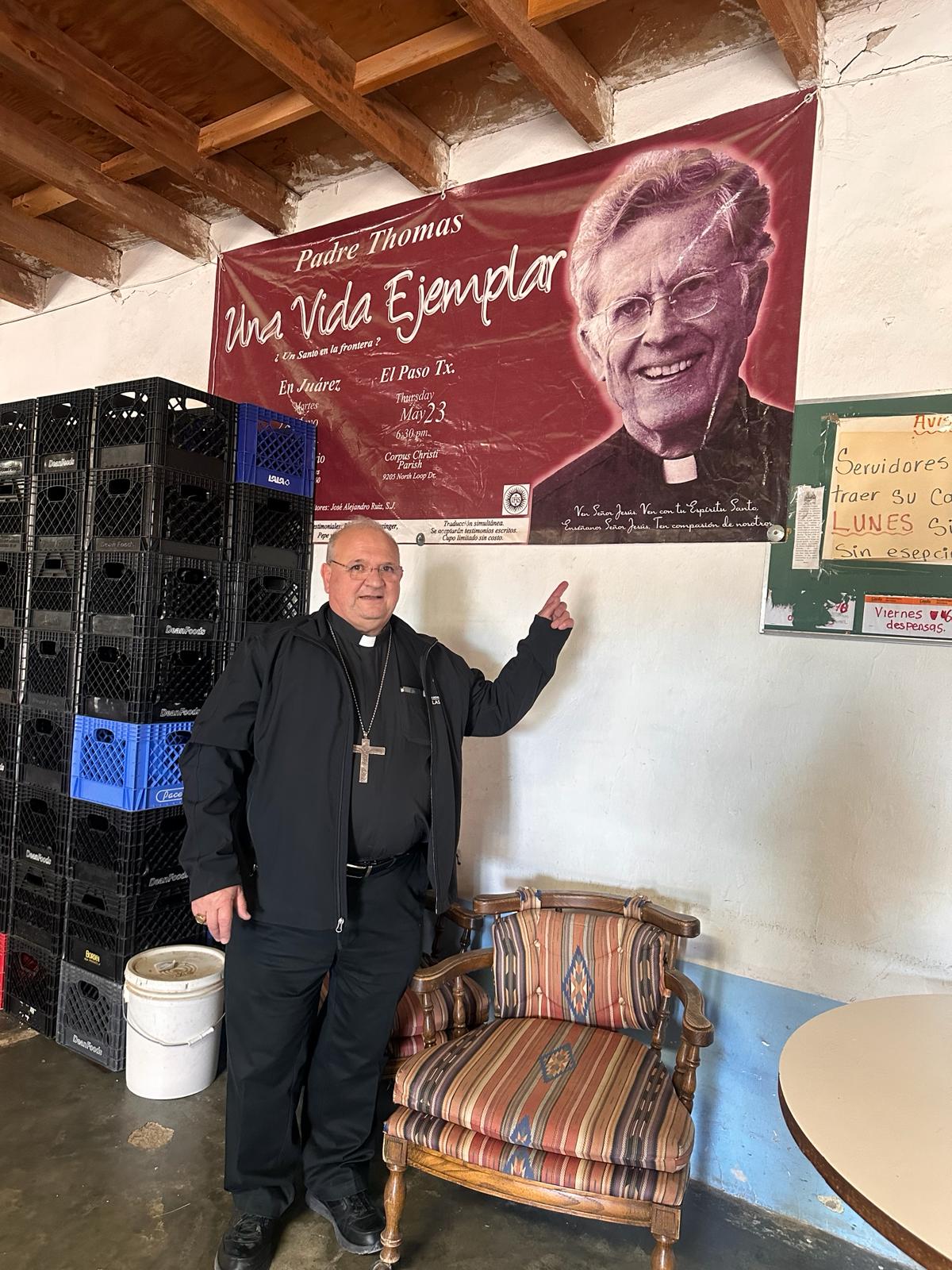 bishop with picture of Fr Rick Thomas